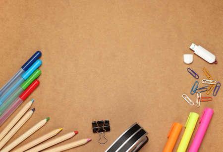 Still life, business, education concept. Office supplies, clips, USB flash drive, stapler,  pens, markers and pencils on a table. Selective focus, copy space background, top viewの写真素材