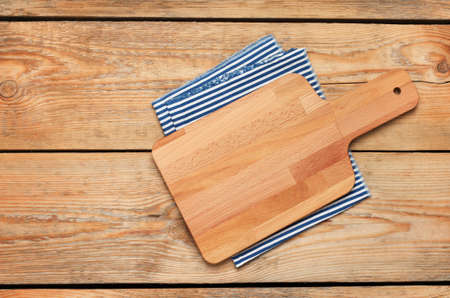 Still life, food and drink concept. Kitchen cooking utensils (cutting board, napkin) on a wooden table. Selective focus, copy space background, top viewの写真素材