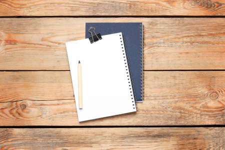 Still life, business, education concept. Office supplies, notepad and a pencil on a wooden table....