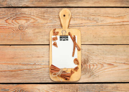 Still life, food and drink concept. Kitchen cooking utensils (cutting board, paper for recipe) on a...