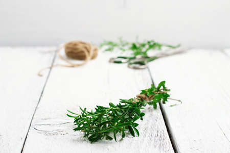 Still life, food and drink, health concept. Fresh herbs (savory) on a wooden table. Selective focus,...