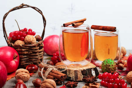Still life, food and drink, seasonal and holidays concept. Autumn hot beverage in a glass with fruits and spices on a wooden background. Selective focusの写真素材