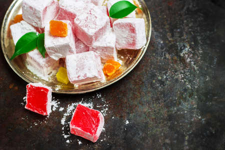 Still life, food and drink, seasonal and holidays (ramadan, seker bayram) concept. Rose turkish delight on a metal grunge table. Selective focus, copy space background, top viewの写真素材