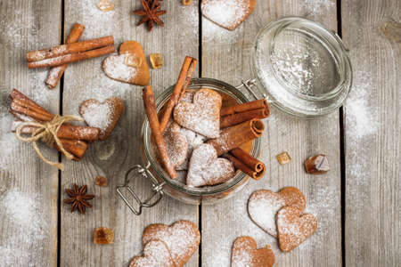 Handmade heart cookies for Valentines day in a jar on a rustic wooden table. Selective focus, top...