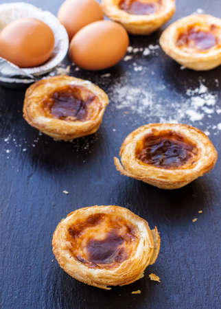Egg tart on a grunge background, traditional portugueser dessert, pasteis de nata. Selective focus