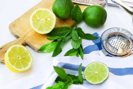Food and drink, still life concept. Fresh lemonade ingredients on a white table. Outdoor summer composition, selective focusの写真素材