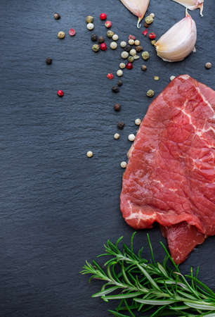 Fresh raw beef from the farmers market on a black grunge table. Selective focus, flat lay, copy spaceの写真素材