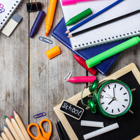 Still life, business, education concept. Office and school supplies, stationery, alarm clock and...