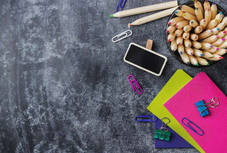 Education, back to school concept. School stationery, supplies, pencil, pen, note on a grunge chalkboard. Selective focus, copy space background, flat lay, top viewの写真素材