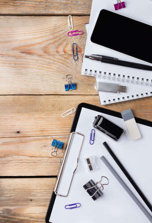 Business, education, office still life concept. Accessories, supplies, stationery, phone on rustic...