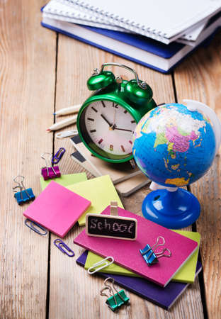 Business, education, office still life concept. Accessories, supplies, alarm clock, pencils on rustic wooden table. Selective focusの写真素材