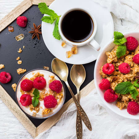 Breakfast, food, still life concept. Coffee muesli granola berries homemade yogurt on a rustic white...
