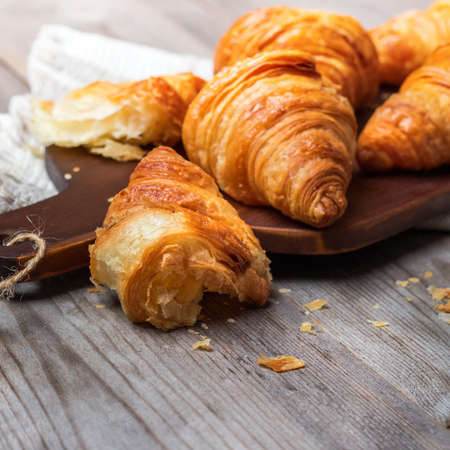 Food and drink, still life concept. Fresh croissants for breakfast on a rustic wooden table. Selective focusの写真素材