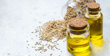 Healthy food and drink concept. Sesame oil and seeds on a rustic table. Copy space backgroundの写真素材