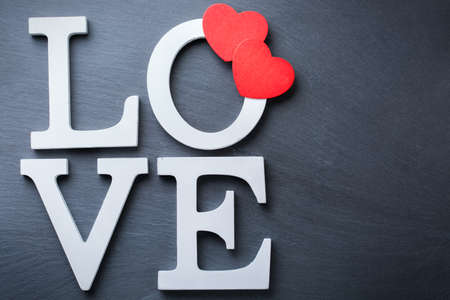 Love and still life concept. Valentines day holiday letters text message card with red hearts. Top view flat lay overhead, copy space backgroundの写真素材