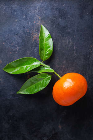 Healthy food, diet, nutrition, nature concept. Citrus fruits tangerine on a grunge black table. Top view flat lay overhead, copy space backgroundの写真素材