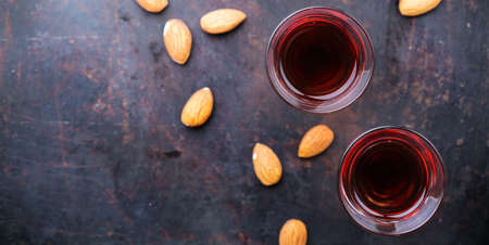 Food and drink, party, alcohol concept. Traditional italian sweet almond liquor amaretto on a grunge...