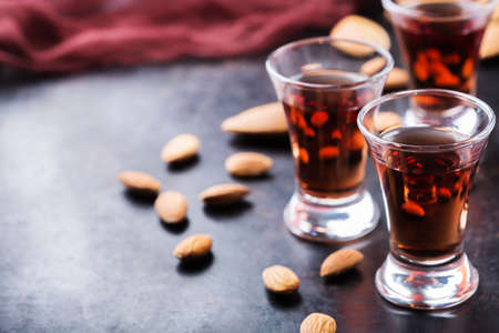 Food and drink, party, alcohol concept. Traditional italian sweet almond liquor amaretto on a grunge...