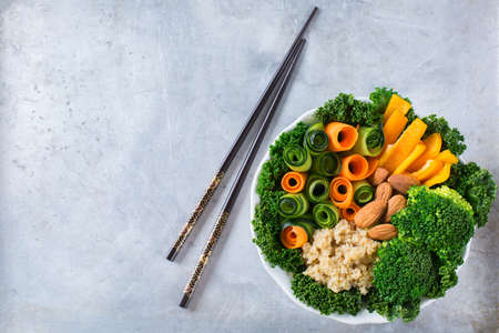 Health care, diet and nutrition concept. Buddha bowl with chopsticks on a rustic table, vegetarian vegan raw balanced detox meal food. Copy space background, top view flat lay overheadの写真素材