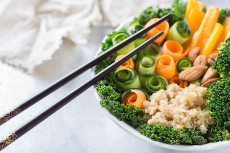 Health care, diet and nutrition concept. Buddha bowl with chopsticks on a rustic table, vegetarian vegan raw balanced detox meal foodの写真素材