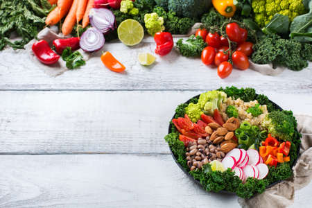 Health care, diet and nutrition concept. Buddha bowl with chopsticks on a white rustic wooden table, vegetarian vegan raw balanced detox meal food. Copy space backgroundの写真素材