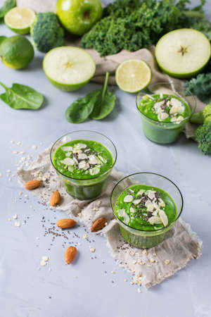 Food and drink, healthy lifestyle, diet and nutrition concept. Green smoothie with organic kale leaves apple broccoli lime spinach, chia seeds, almond and oat vegan milk.の写真素材