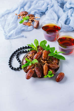 Ramadan ramazan kareem. Traditional arabic tea with mint and dates for iftar party holidays. Copy...