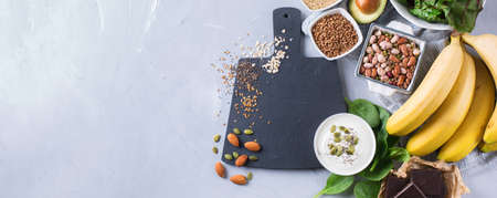 Healthy food nutrition dieting concept. Assortment of high magnesium sources. Banana chocolate...