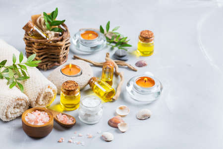 Spa wellness setting concept. Assortment of essential oil cream sea salt natural soap candles and towel. Copy space backgroundの写真素材