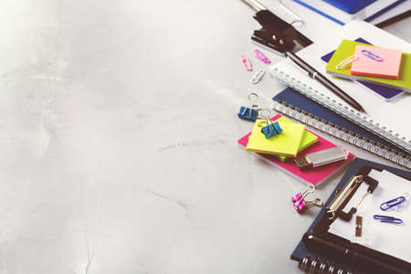 Back to school, business office education concept. Assortment of supplies, crayons, pens, notebook on a table. Copy space background, toned imageの写真素材