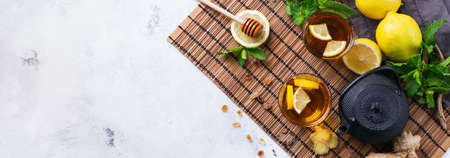 Japanese chinese tea teapot lemon ginger honey on a rustic tableの写真素材