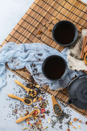Food and drink, still life concept. Selection assortment of japanese chinese herbal masala tea infusion beverage teapot on the table. Top view flat layの写真素材