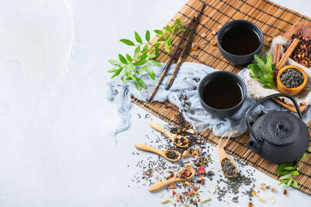 Selection assortment of different Japanese and Chinese herbs and masala tea infusion beverage teapot on the table.の写真素材