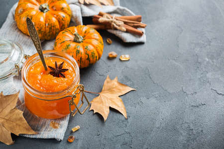 Food and drink, still life, thanksgiving harvest fall autumn concept. Pumpkin jam or confiture with spices on a cozy kitchen table. Copy space backgroundの写真素材