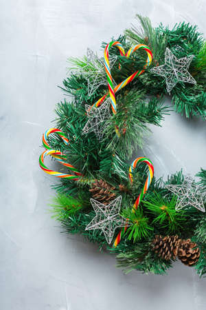 Holidays new year concept. Advent christmas door wreath with festive decoration on a cozy background. Flat lay top viewの写真素材