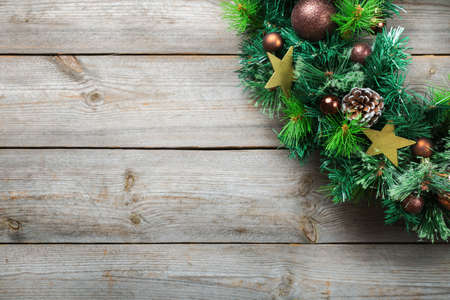 Holidays new year concept. Advent christmas door wreath with festive decoration on a cozy wooden background. Copy space flat lay top viewの写真素材