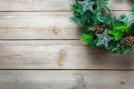 Holidays new year concept. Advent christmas door wreath with festive decoration on a cozy wooden background. Copy space flat lay top viewの写真素材