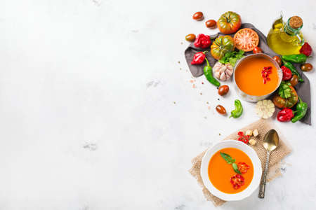 Food and drink, still life, diet and nutrition concept. Seasonal red tomato pepper soup gazpacho with ingredients on a table. Top view flat lay, copy space backgroundの写真素材