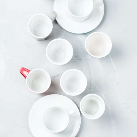 Breakfast relaxation time restaurant concept. Different white empty coffee and tea mugs and cups on a cozy kitchen table. Top view flat lay backgroundの写真素材