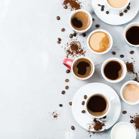 Breakfast relaxation time concept. Different coffee mugs and cups on a cozy kitchen table. Copy space, top view flat lay backgroundの写真素材
