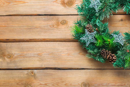 Holidays new year concept. Advent christmas door wreath with festive decoration on a cozy wooden background. Copy space flat lay top viewの写真素材