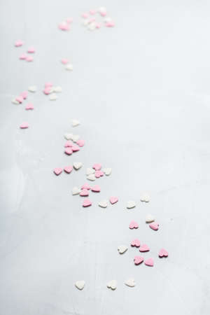 Love and still life concept. Valentines day holiday card with pink hearts. Trendy copy space background, top view flat layの写真素材