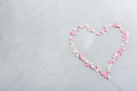 Love and still life concept. Valentines day holiday card with pink heart. Trendy copy space background, top view flat layの写真素材
