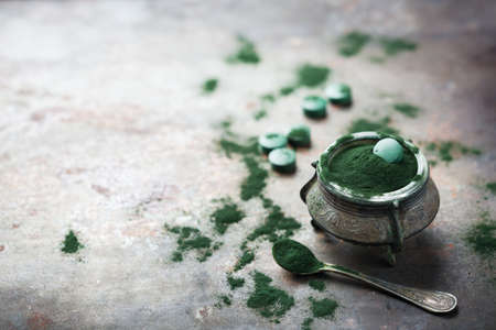 Diet and nutrition, superfood vegan organic healthy lifestyle concept. Ground spirulina algae powder...