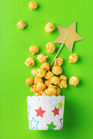 Junk sweet food concept. Portion of caramel popcorn in paper glasses boxes ready for party holidays...