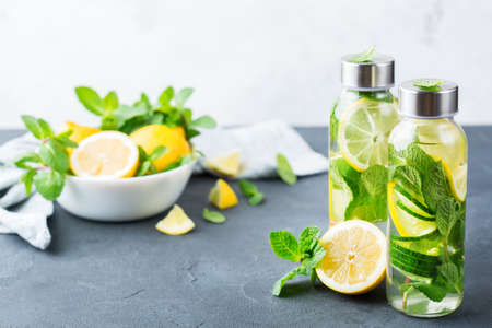 Health care, fitness, healthy nutrition diet concept. Fresh cool lemon cucumber mint infused water, cocktail, detox drink, lemonade in a glass jar for spring summer daysの写真素材