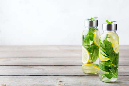 Health care, fitness, healthy nutrition diet concept. Fresh cool lemon cucumber mint infused water,...