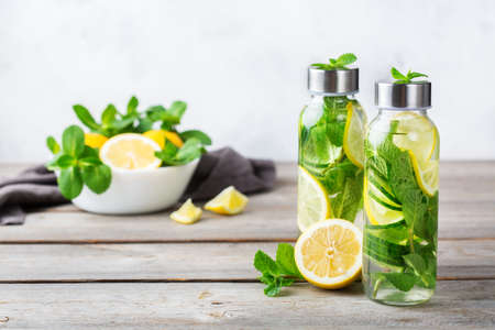 Health care, fitness, healthy nutrition diet concept. Fresh cool lemon cucumber mint infused water, cocktail, detox drink, lemonade in a glass jar for spring summer daysの写真素材