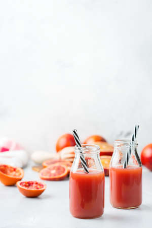 Food and drink, health care, diet and nutrition concept. Fresh red blood orange juice from ripe organic citrus fruits in a bottle for breakfast on a kitchen table. Spring summer beverageの写真素材