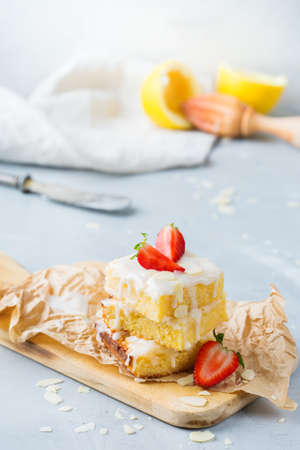 Food, breakfast teatime concept. Homemade lemon polenta cookie bars with white icing on a kitchen...